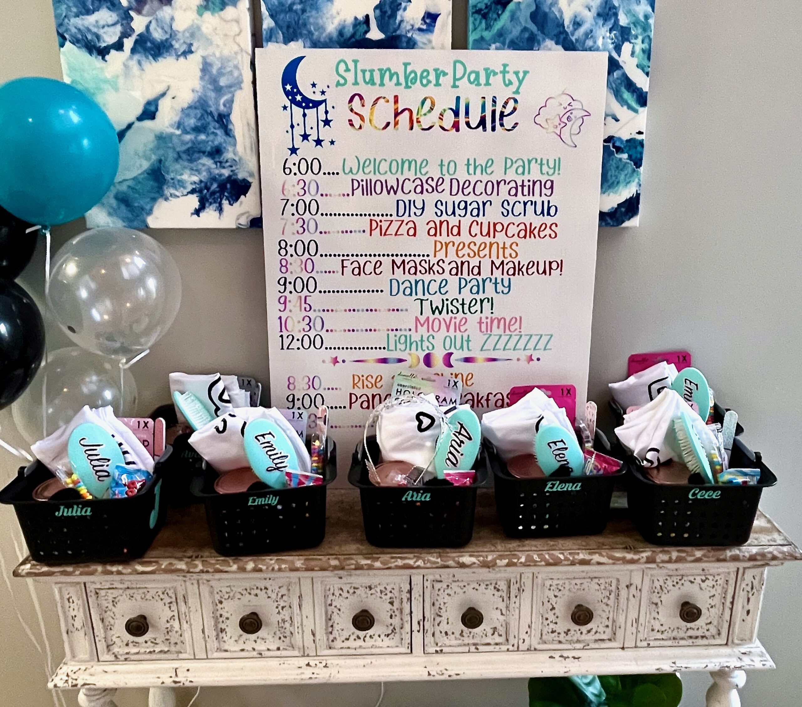 Welcome table at sleepover birthday party, with favor baskets filled with sleepover supplies
