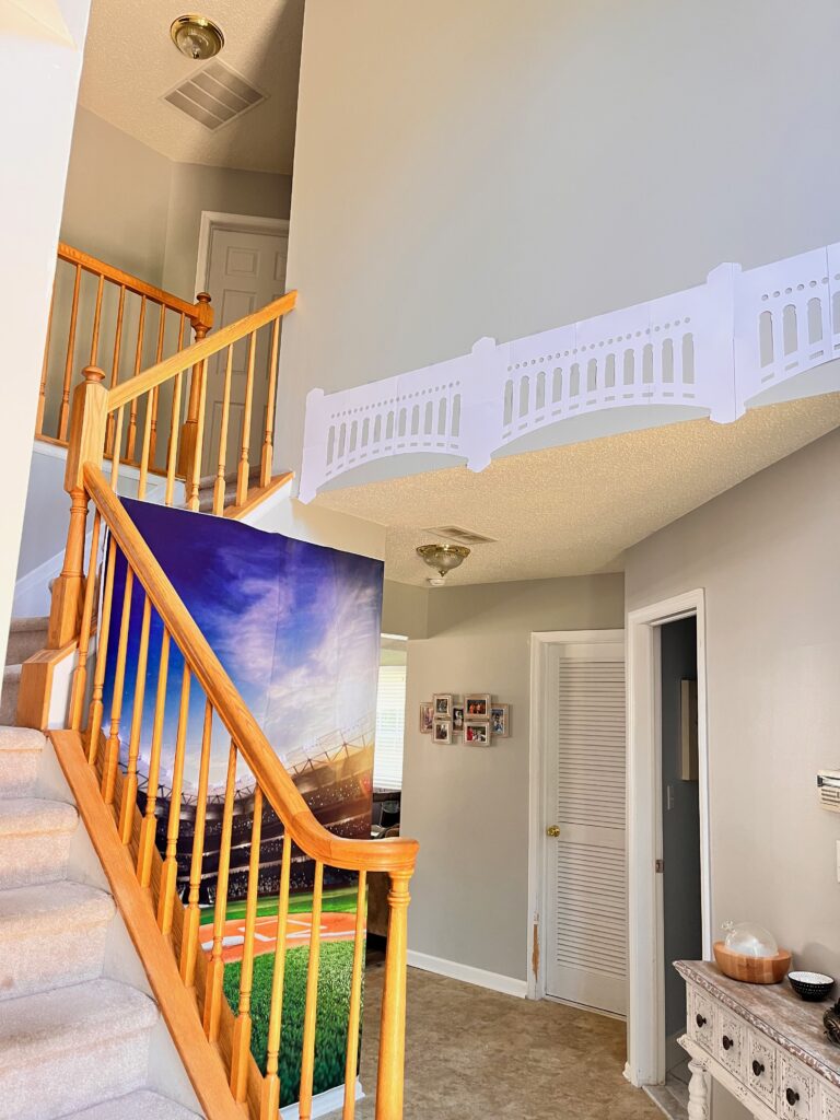 Foyer with baseball photo back drop and Yankee stadium arches