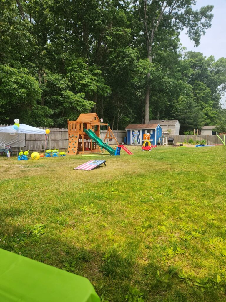 backyard with swingset and party games