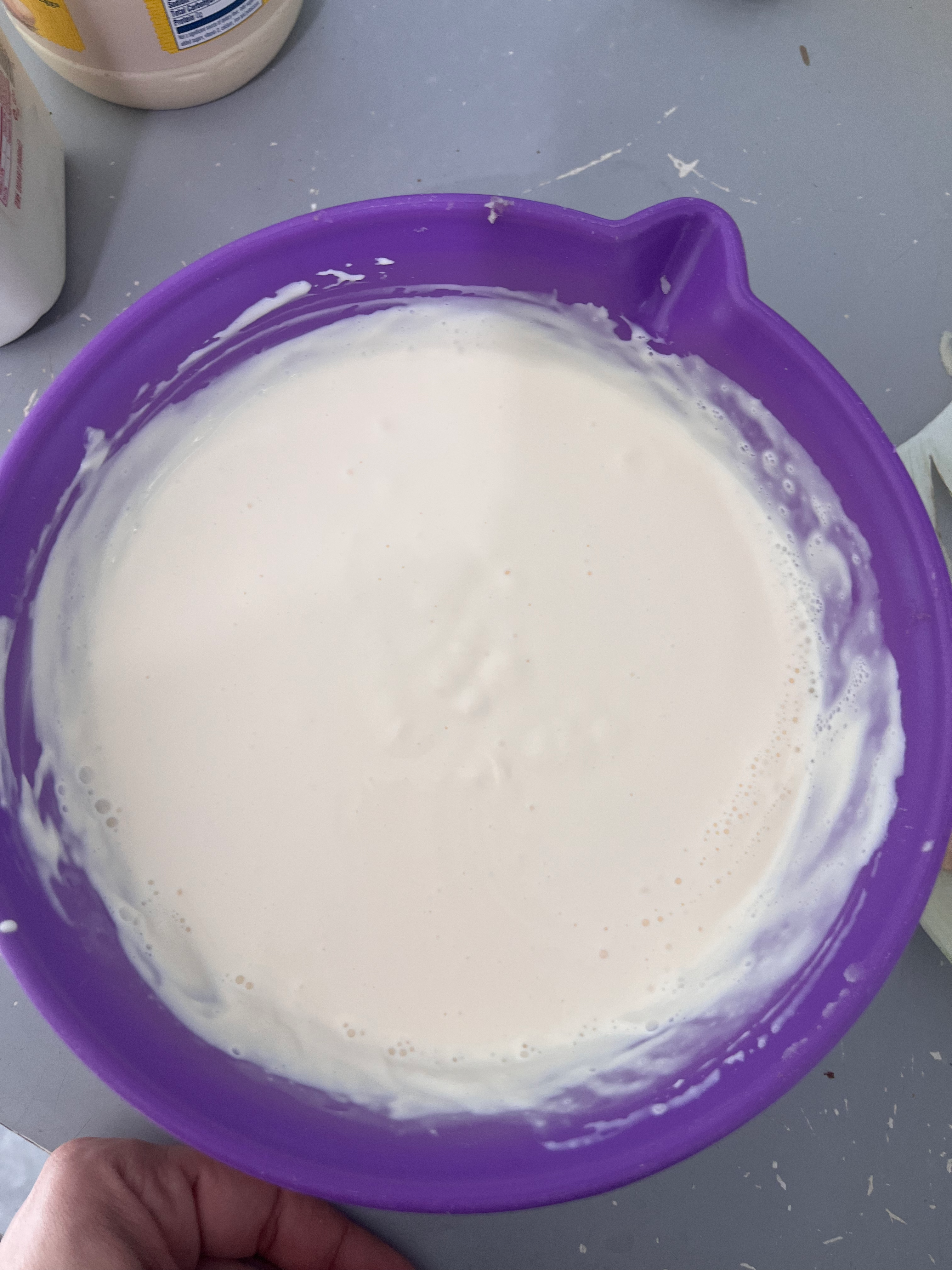 Creamy mayonnaise mixture in a purple bowl, ready to be folded into Nan’s homemade potato salad