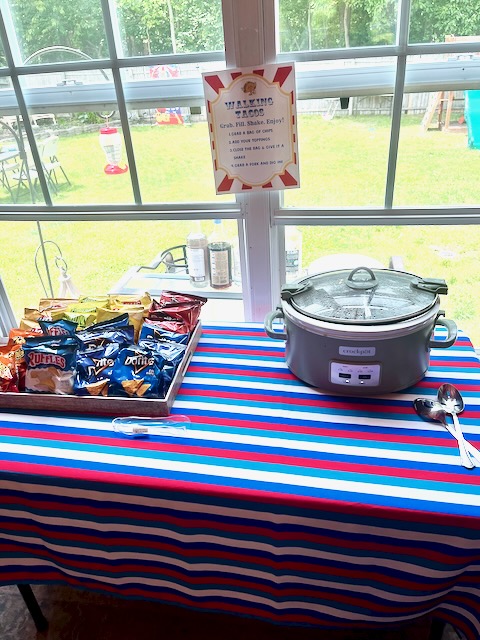 DIY walking taco bar with chip bags and slow cooker for a carnival-themed kids’ birthday party food station