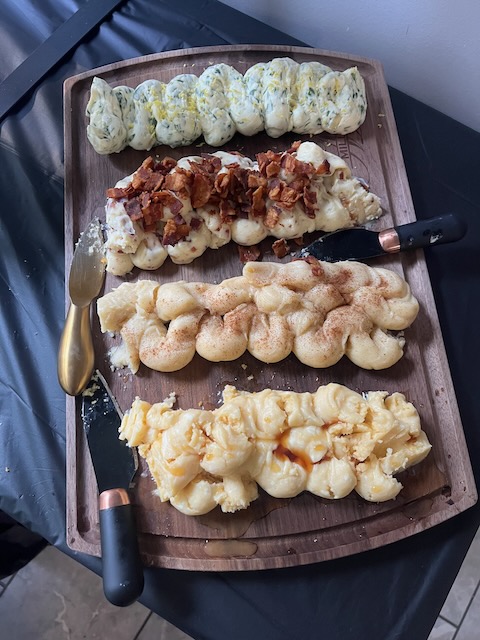 Rustic butter board at a Bourbon & BBQ 40th birthday party with four flavored compound butters, including herb, bacon, cinnamon sugar, and honey drizzle.