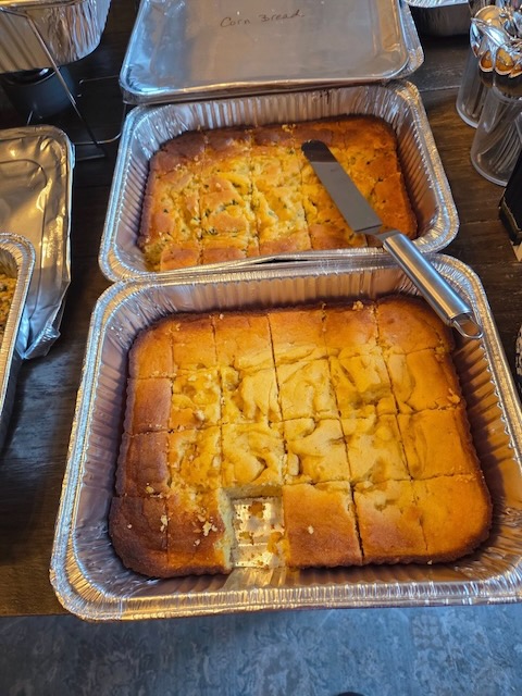 Two pans of cornbread, one plain and one jalapeño, served buffet-style at a Bourbon & BBQ 40th birthday party.