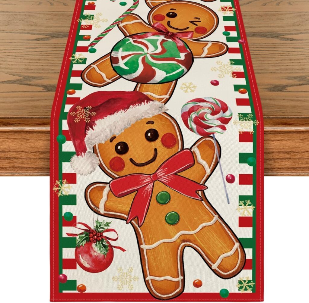 Gingerbread man Christmas table runner featuring smiling gingerbread cookies, red and green candy, and festive holiday accents on a wooden table.