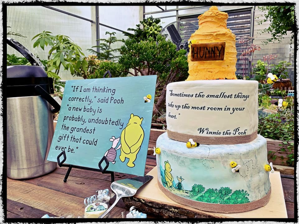Elegant vintage Winnie the Pooh baby sprinkle cake with hunny pot topper, bee accents, and classic storybook quote sign